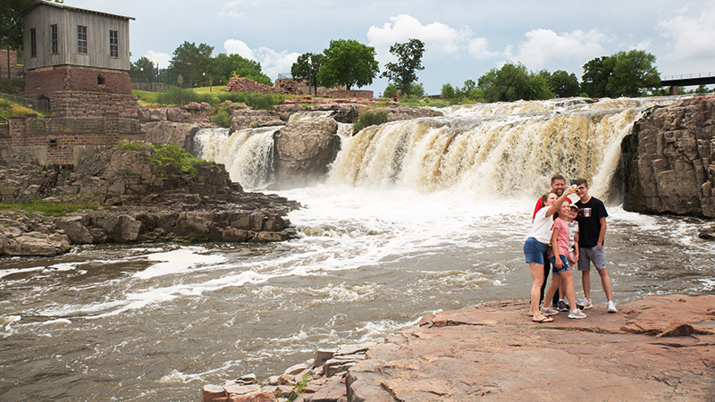 Family taking a selfie in front of The Falls