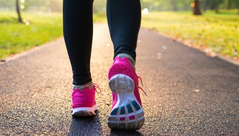 an image of someones feet from behind walking on a path