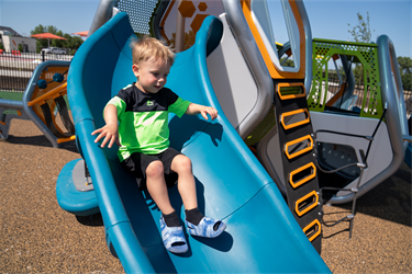 Youngster on the slide at Jacobson Plaza